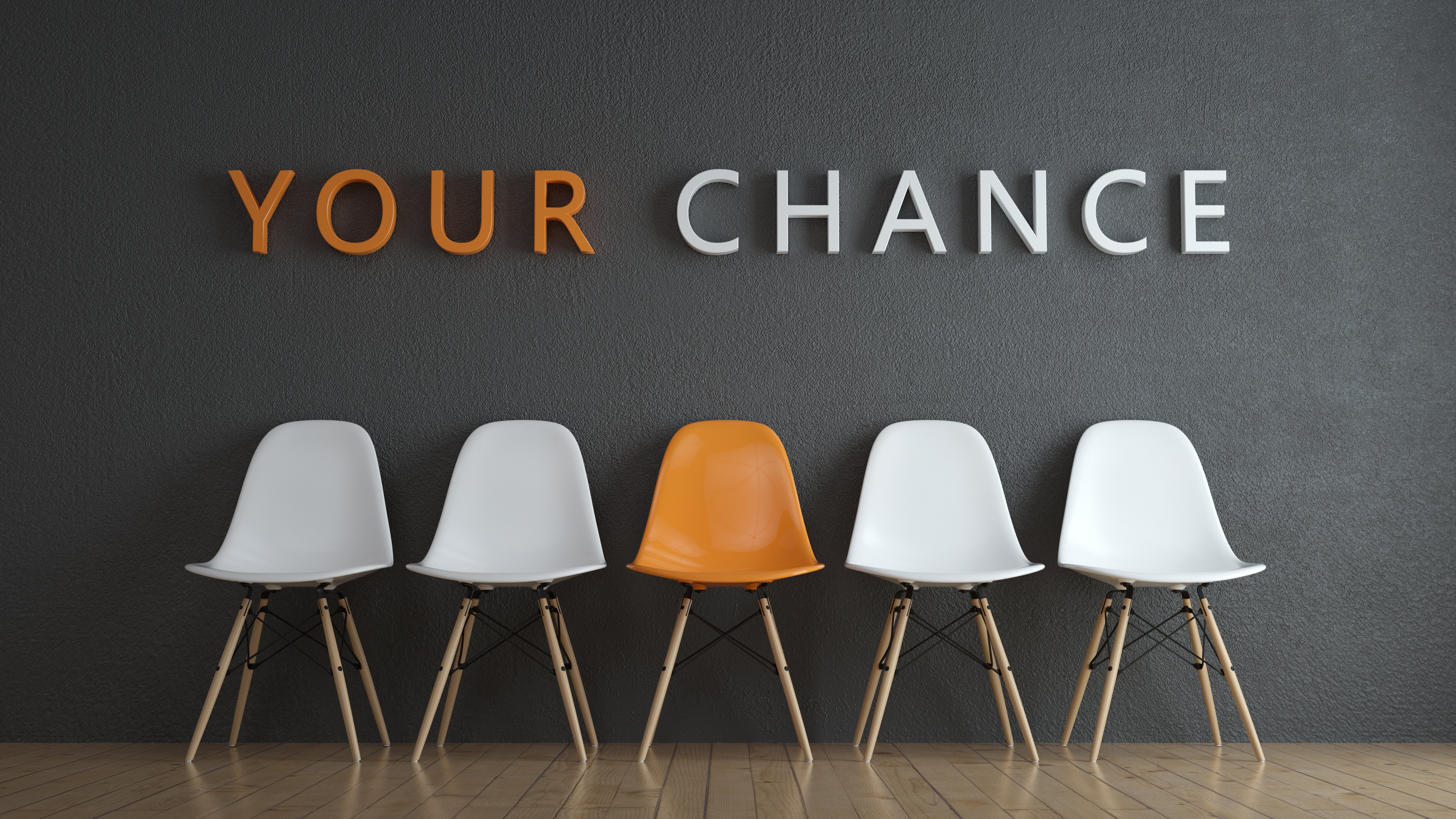 Das Bild zeigt fünf Stühle, vier weiße und einen orangen in der Mitte, mit dem Schriftzug "Your Chance" darüber. - Jetzt bewerben und Karriere bei Schneider Schirme machen.