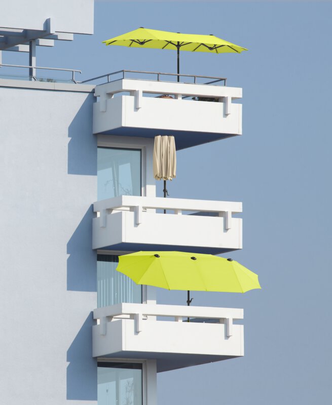 Schneider Salerno parasol in ecru and apple green, 300x150 cm - the parasols can be seen on three balconies, one below the other, open and closed.