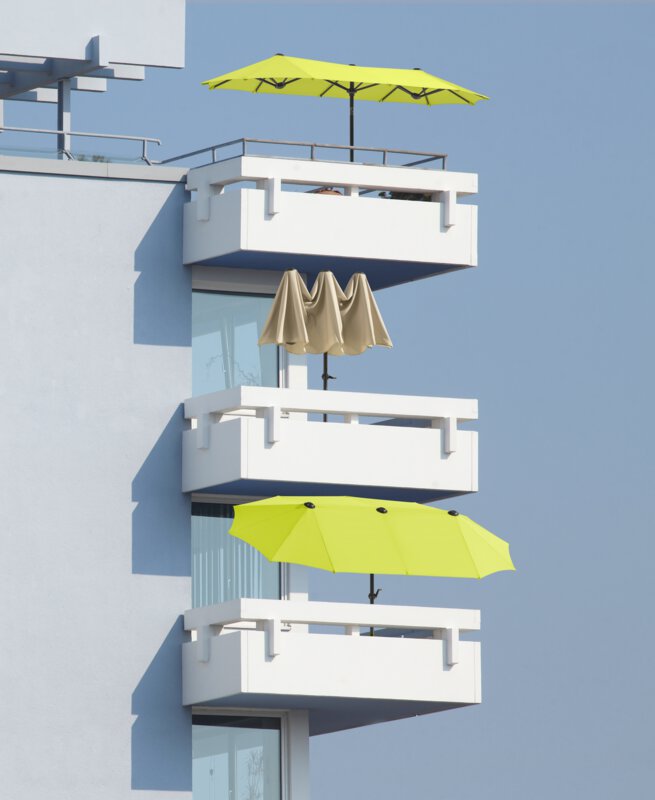 Schneider Salerno parasol in ecru and apple green, 300x150 cm - the parasols can be seen on three balconies, one below the other, open and half-open.